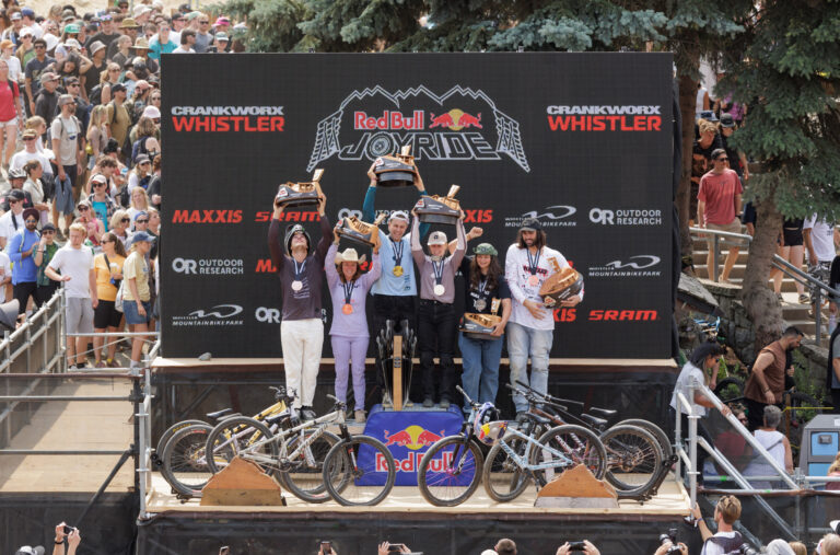 Women and men on the medal podium at the Red Bull Joyride event during Crankworx Whistler.