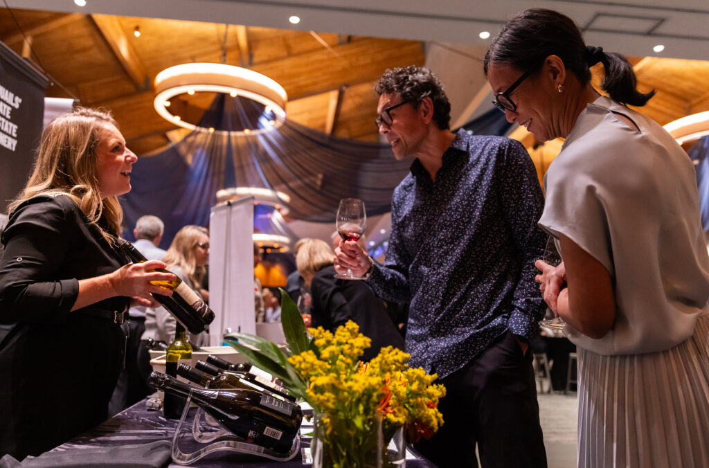 A couple peruse the options at a wine tasting table at Whistler Cornucopia.