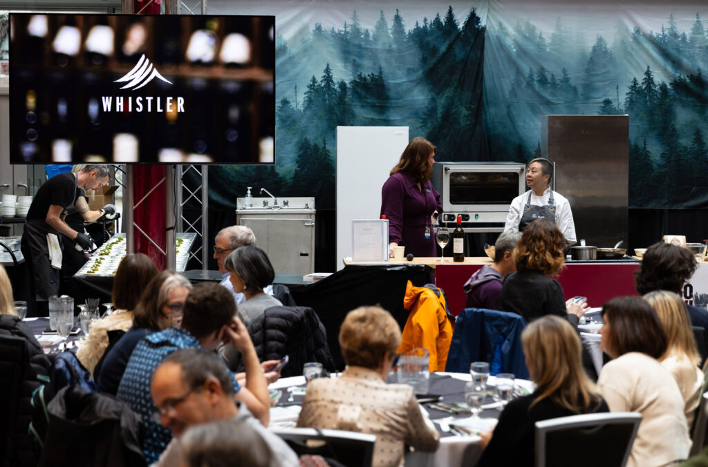 A chef does a cooking demo at the Culinary Stage event at Whistler Cornucopia.