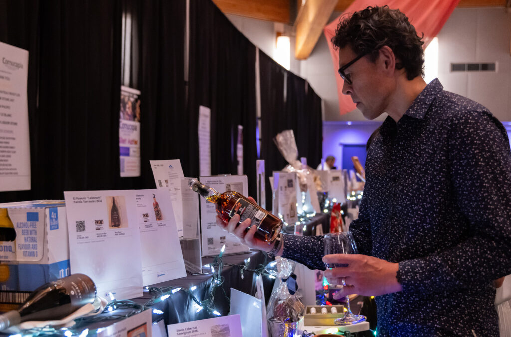 A person looks at a whisky bottle at one of the drink events at Whistler Cornucopia.