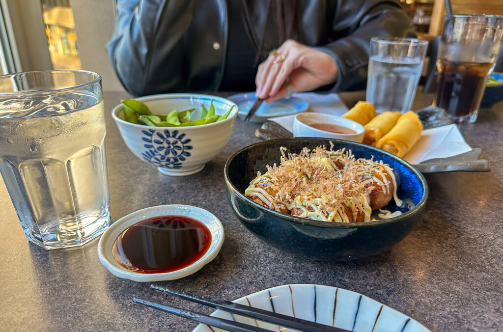 A shot of the starters at Nagomi Sushi including edamame beans and sushi rolls.