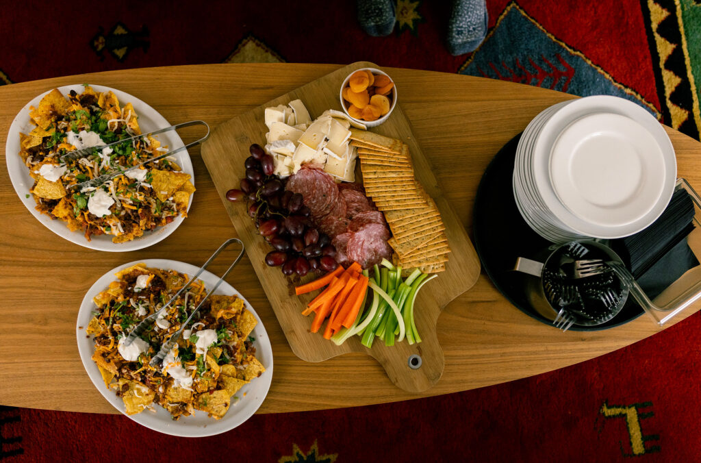 A colourful apres platter of nachos, cheese and charcuterie laid out on a coffee table at the Journeyman Lodge in the Callaghan Valley, Whistler.