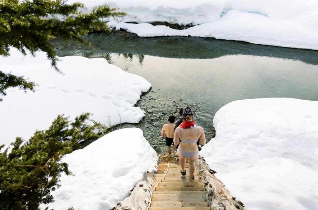 Three friends head down for a cold dip in a lake before they get into the sauna at the Journeyman Lodge in the Callaghan Valley, Whistler.