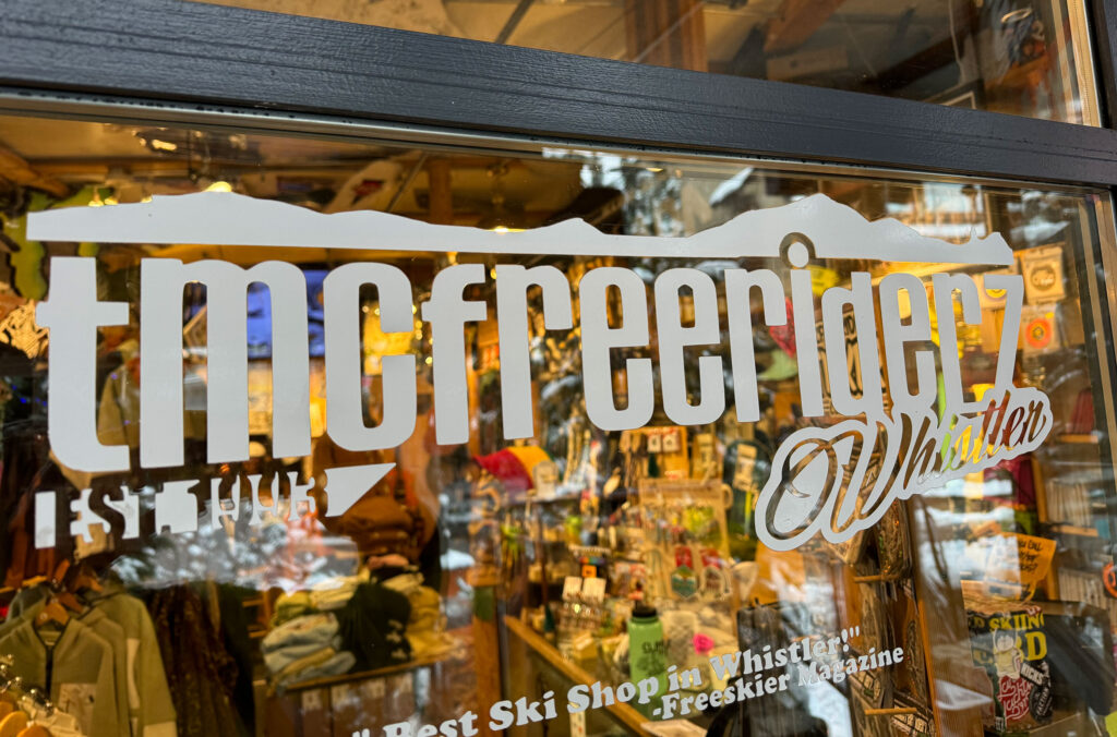 The TMC Freeriderz logo on the front window of the store in Whistler.