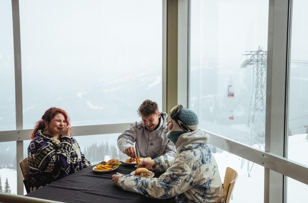 three people having lunch in the roundhouse lodge.