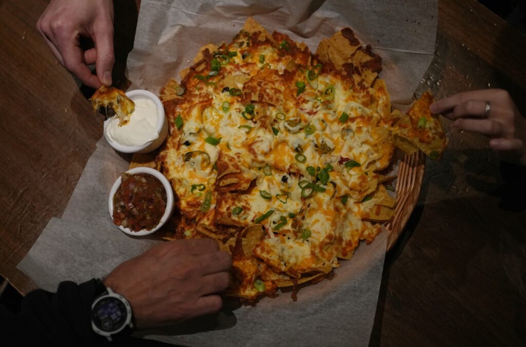 People sharing nachos