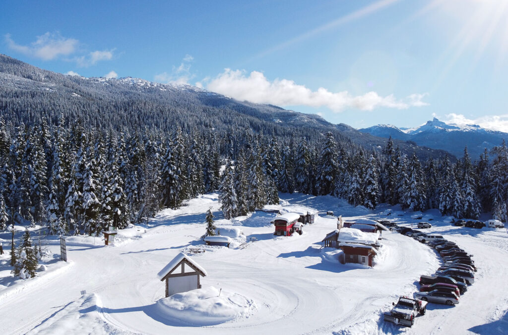 The base area at The Callaghan in the winter sunshine. You can see the base hut, red bus and parking area.