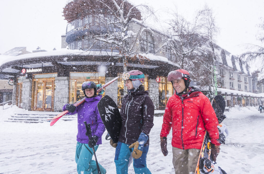 skiers and boarders walking to whistler gondola on a snow winter day in Whistler, BC.