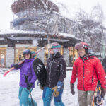 skiers and boarders walking to whistler gondola on a snow winter day in Whistler, BC.