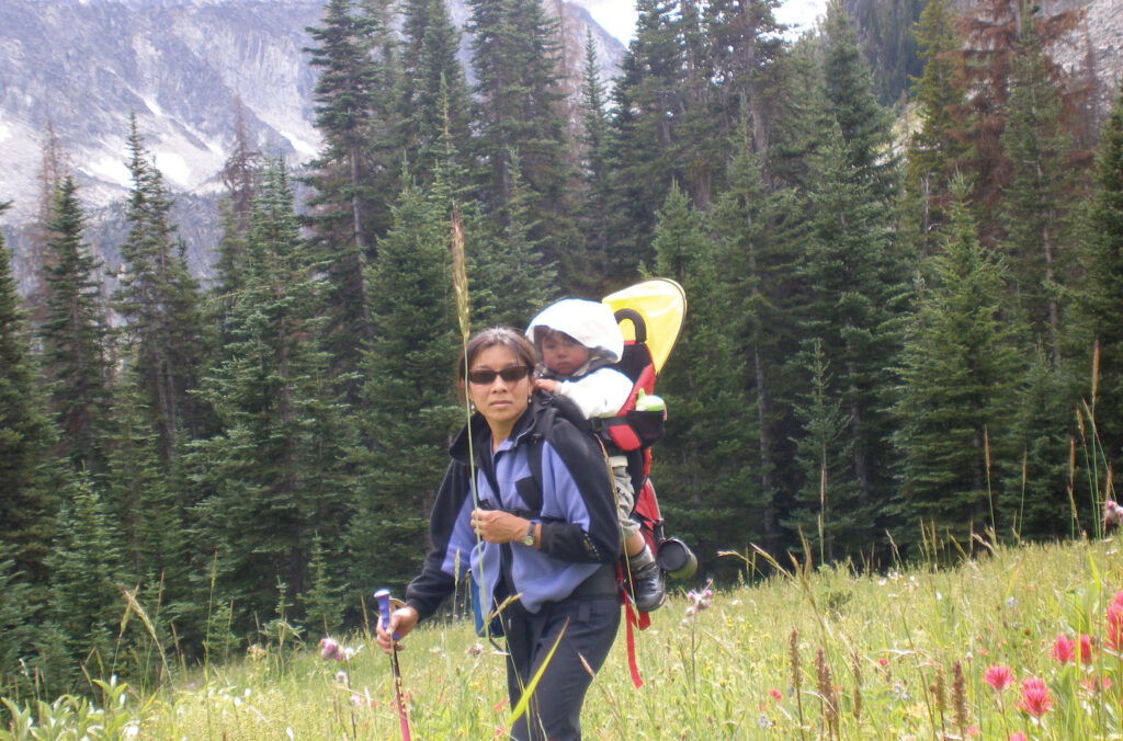 WeiTien in a backpack with his mom as they hike.