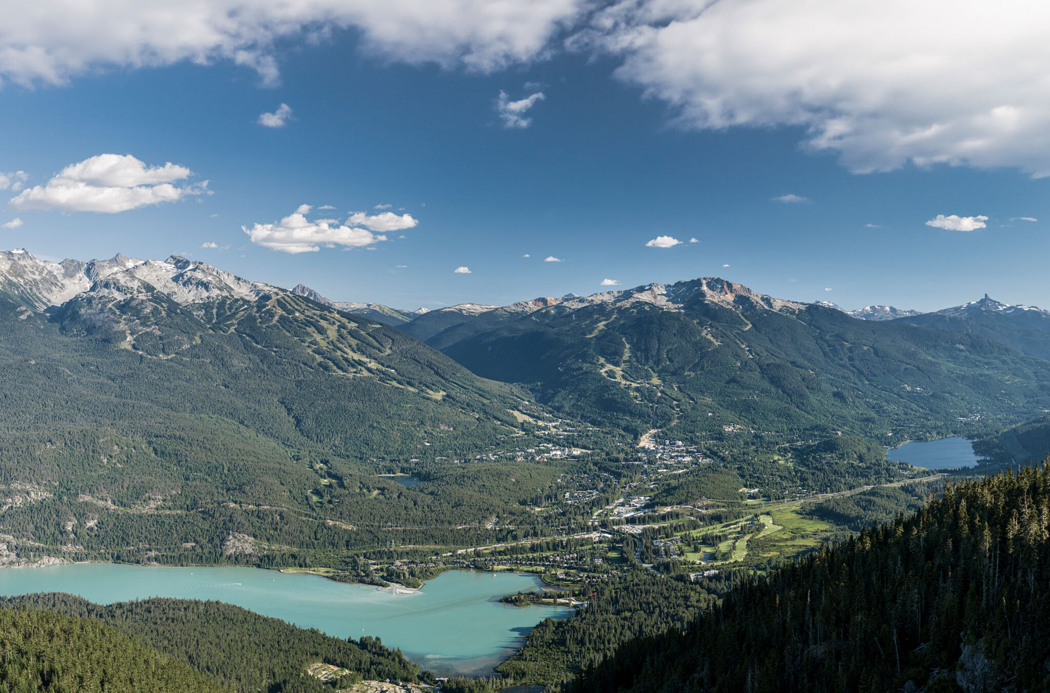 The Whistler Valley in the summertime. Snowcapped mountains, sparkling lakes and lush, green forests.