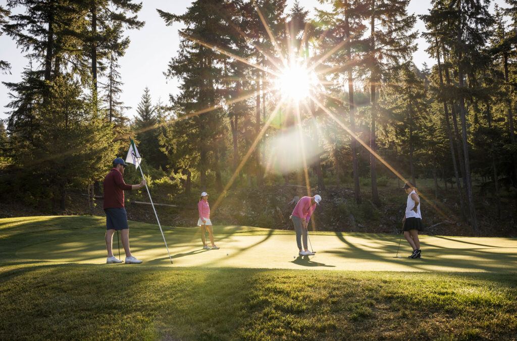 Golfers enjoy the fading summer sun on a golf course in Whistler.