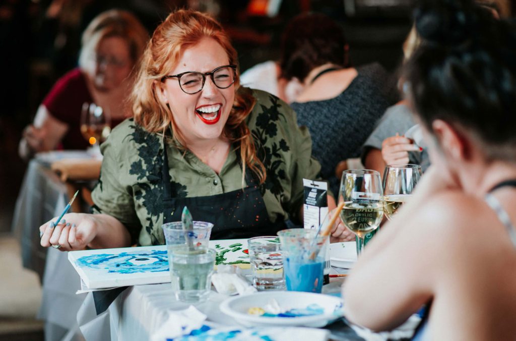 Two people have fun at a paint night in Whistler, which is part of the Nourish Wellness Series.