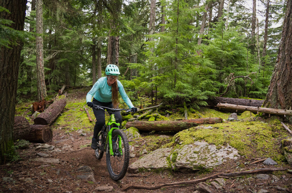 Insider, Hannah Hughes, cross-country bikes through the forest in Whistler.