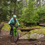 Insider, Hannah Hughes, cross-country bikes through the forest in Whistler.