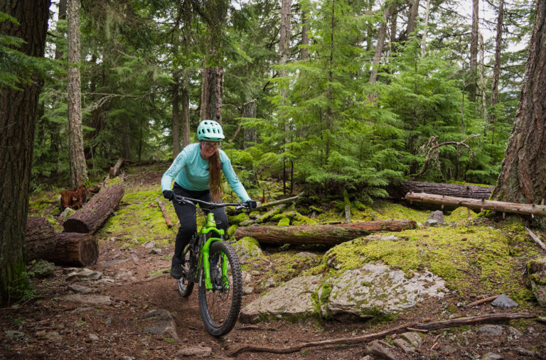 Insider, Hannah Hughes, cross-country bikes through the forest in Whistler.