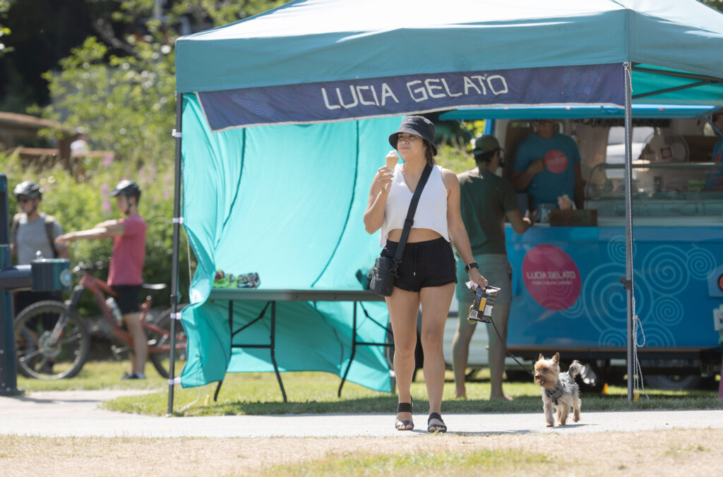 A person licks their gelato cone as they come away from the Lucia Gelato food truck at one of Whistler's parks.