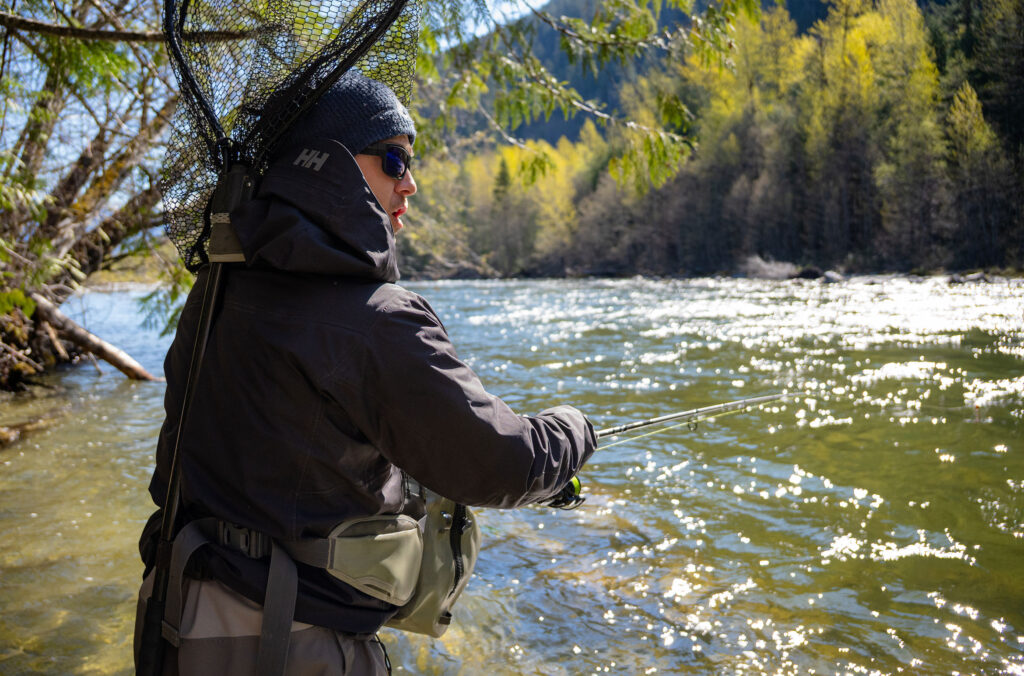 Matthew Prosdocimi, owner of Whistler Year-Round Fishing, wades into the shallows of a Whistler river to fish.