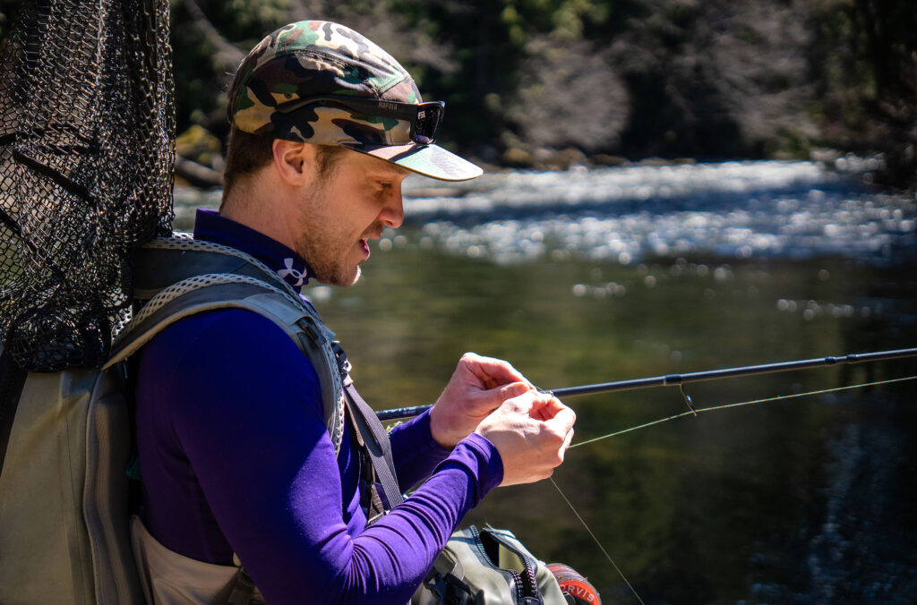 Matthew Prosdocimi, owner of Whistler Year-Round Fishing, prepares his line before casting into a Whistler river to see what he can catch.