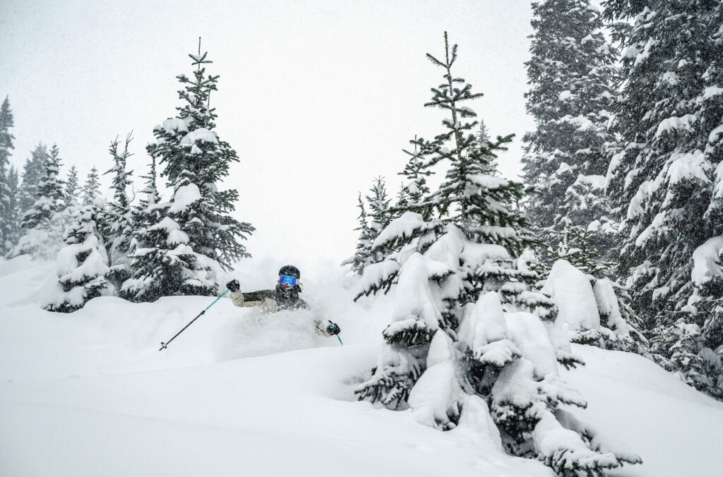 A skier charges through snowy powder on Whistler Blackcomb.