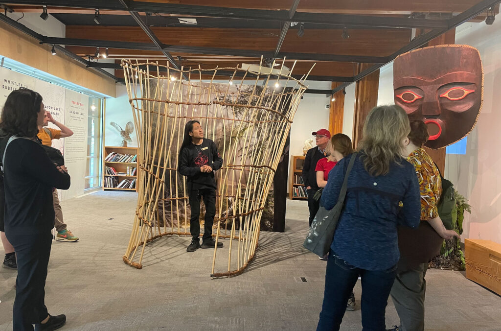 A Cultural Ambassador tells a story during a tour of the Legends of the Land exhibit at the SLCC.