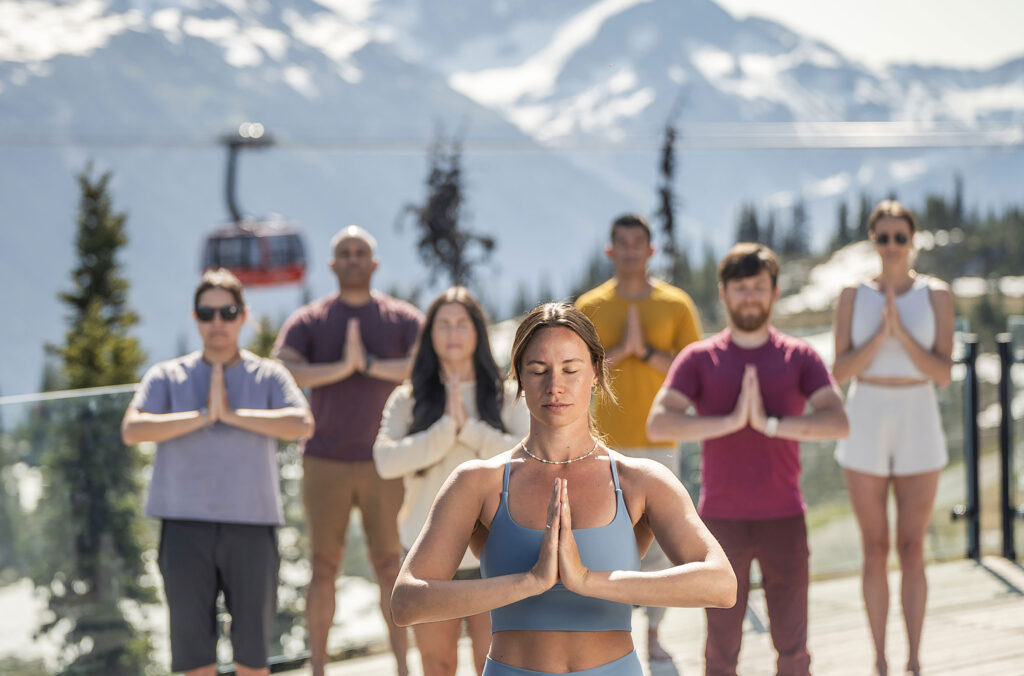 A yoga class at the top of Whistler Blackcomb on a summer's morning.