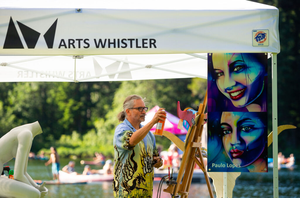 A painter works on this piece floating on a dock in one of Whistler's lakes.