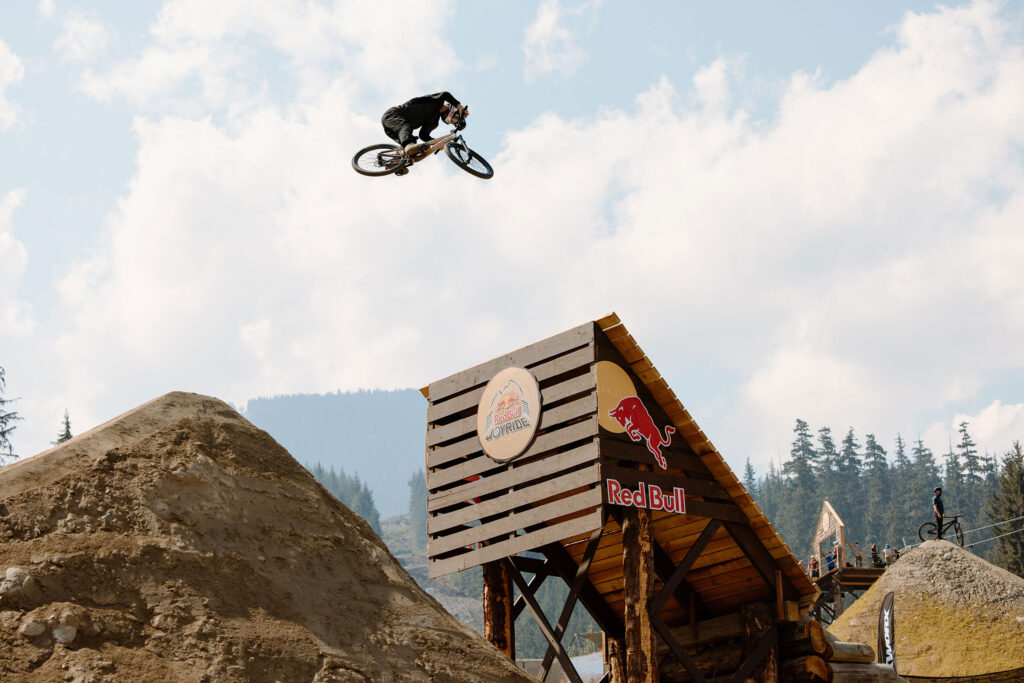 A bike athlete takes to the air while jumping off a feature at the Redbull Joyride event at Crankworx Whistler.