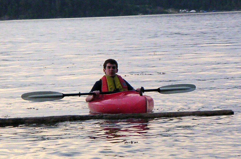 A young Sean Marihugh paddles in a kayak.