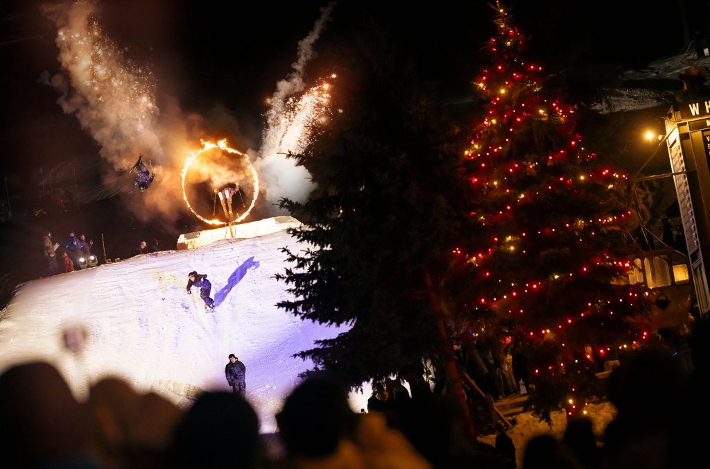 A skier jumps through a fiery hoop at the Whistler Blackcomb Fire and Ice Show.