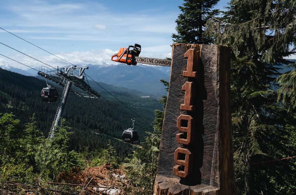 A chainsaw hangs out of the 1199 trail marker on Whistler Blackcomb.