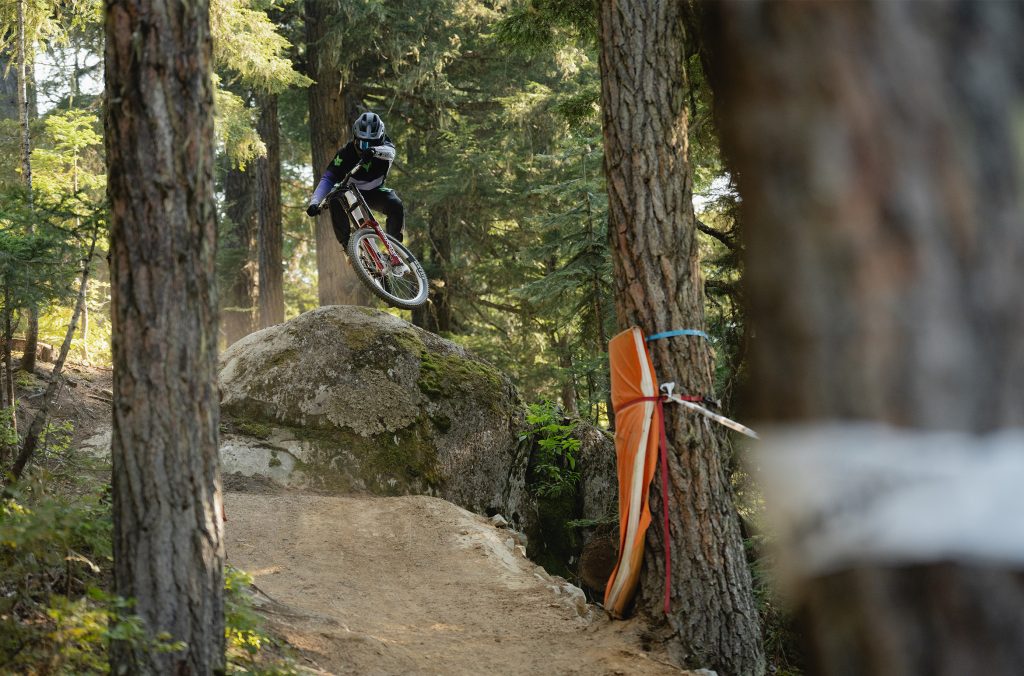A mountain bike rider hits a rock feature on the pro 1199 trail.