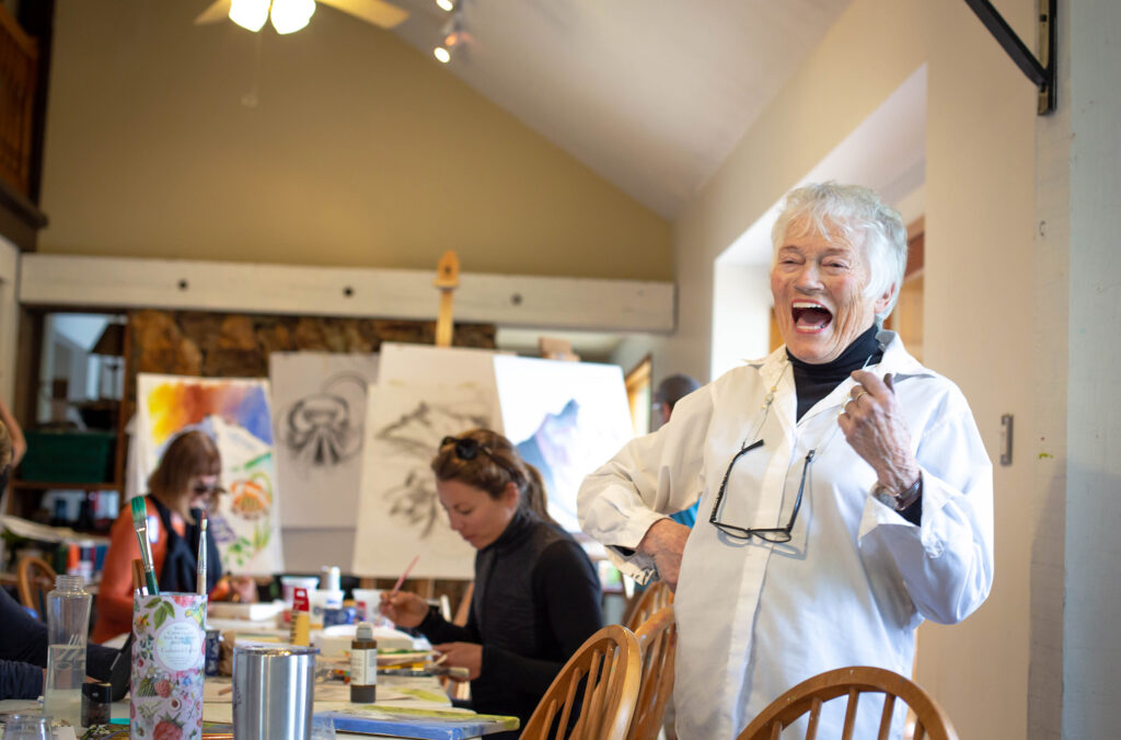 The late Isobel MacLaurin laughs during a painting session.