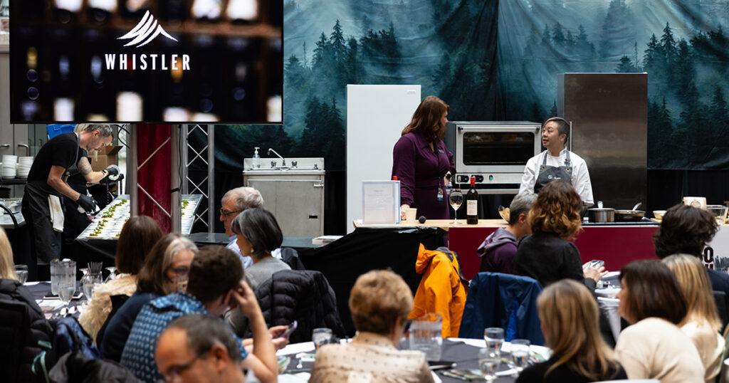 A chef does a cooking demo at the Culinary Stage event at Whistler Cornucopia.