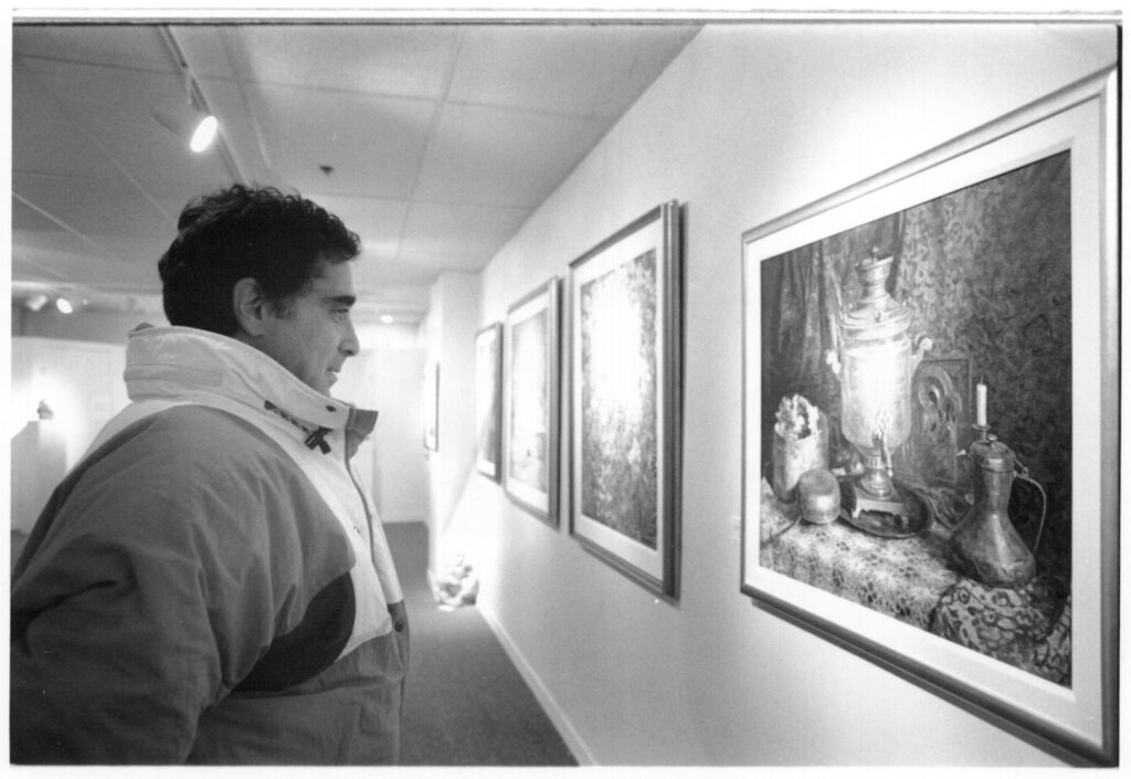 David Banks checks out an oil painting by Russian artist E. Troshev at Whistler newest Gallery - The Art Gallery" 1993.