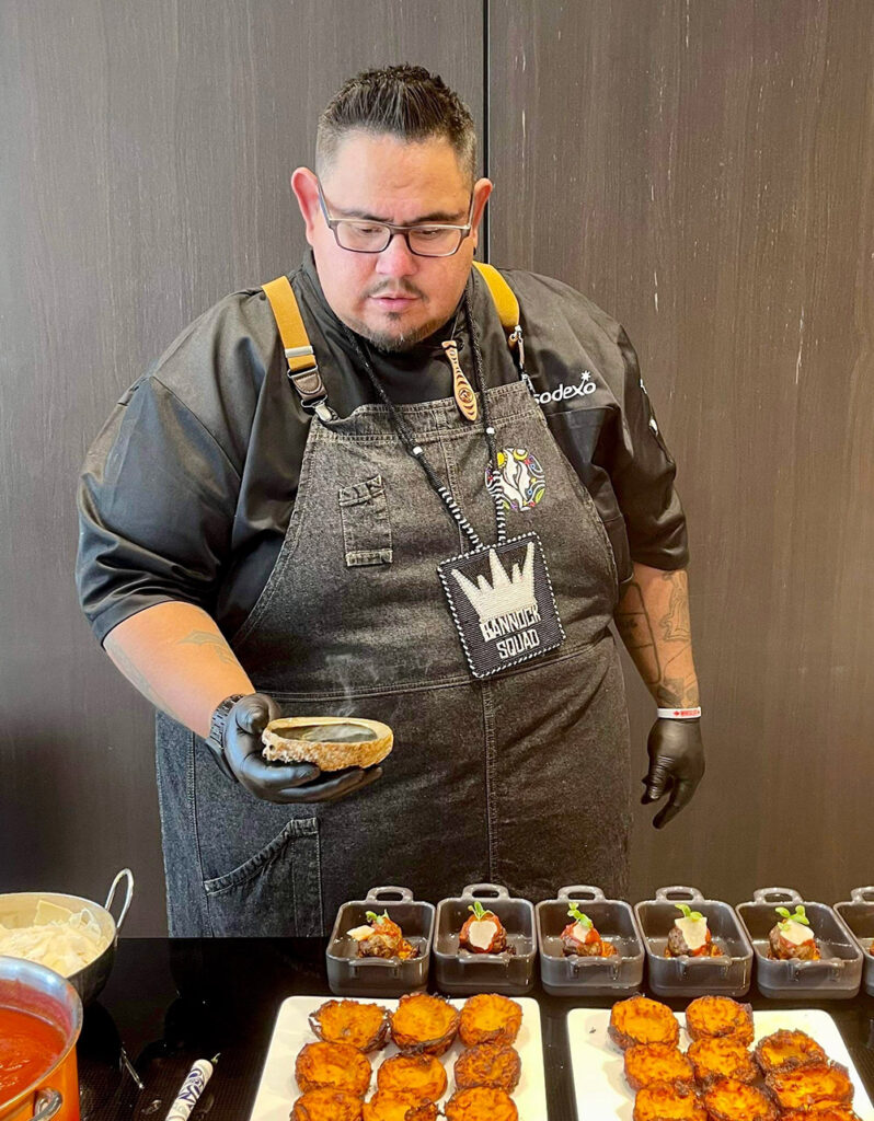 Chef Paul Natrall lays out food at an event.