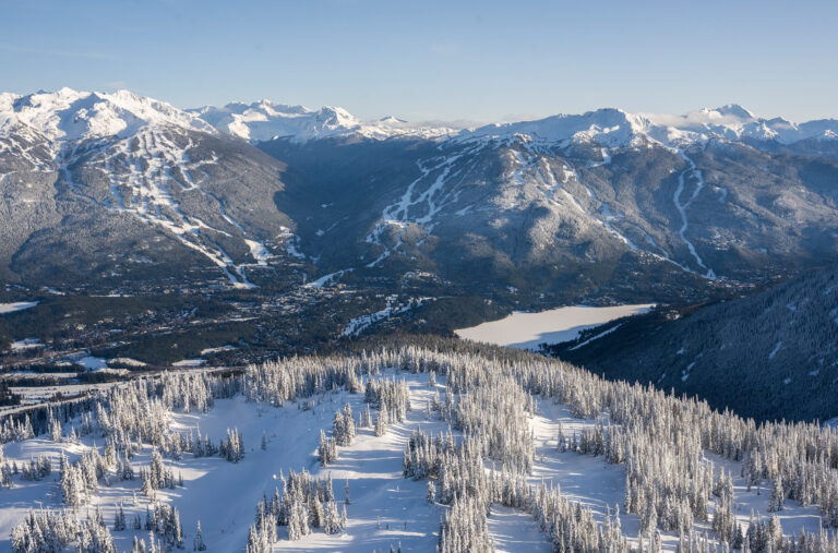 Whistler and Blackcomb Mountains decked in snow as seen from across the Whistler Valley.