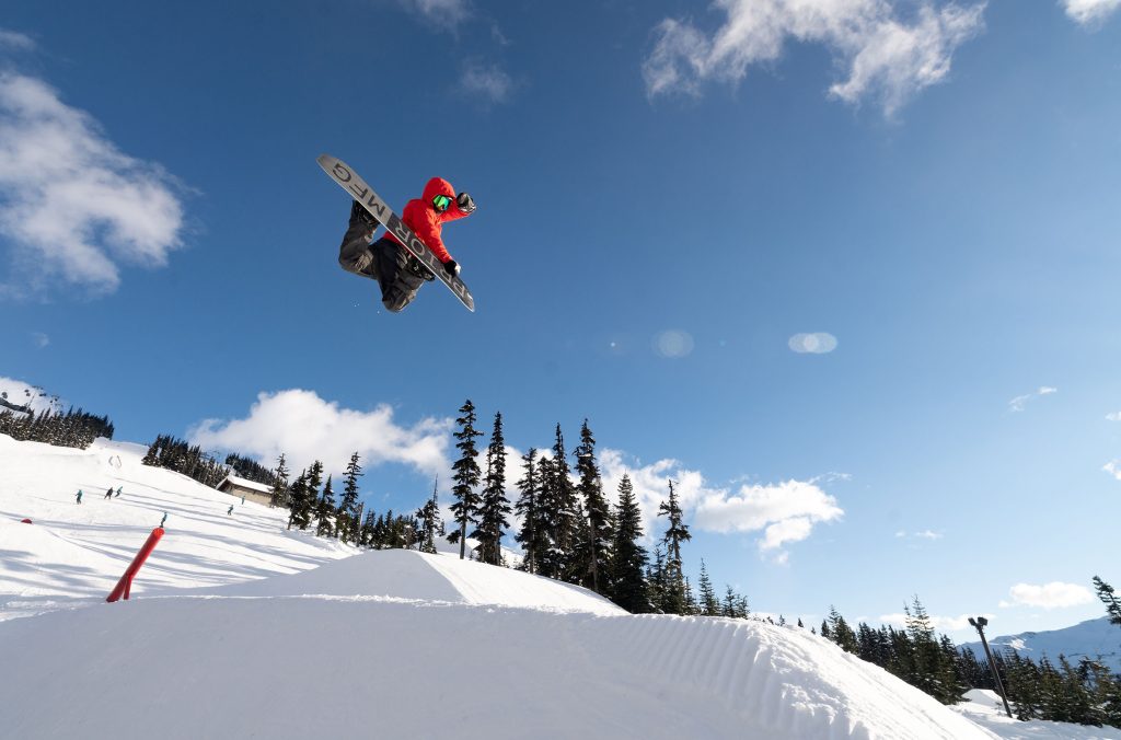 A snowboarder does a trick on one of the features in the terrain park on Whistler Blackcomb.