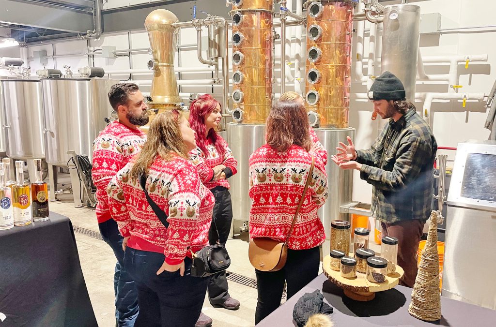 A tour group with Whistler Valley Tours enjoy a tasting at Whistler's Montis Distillery.