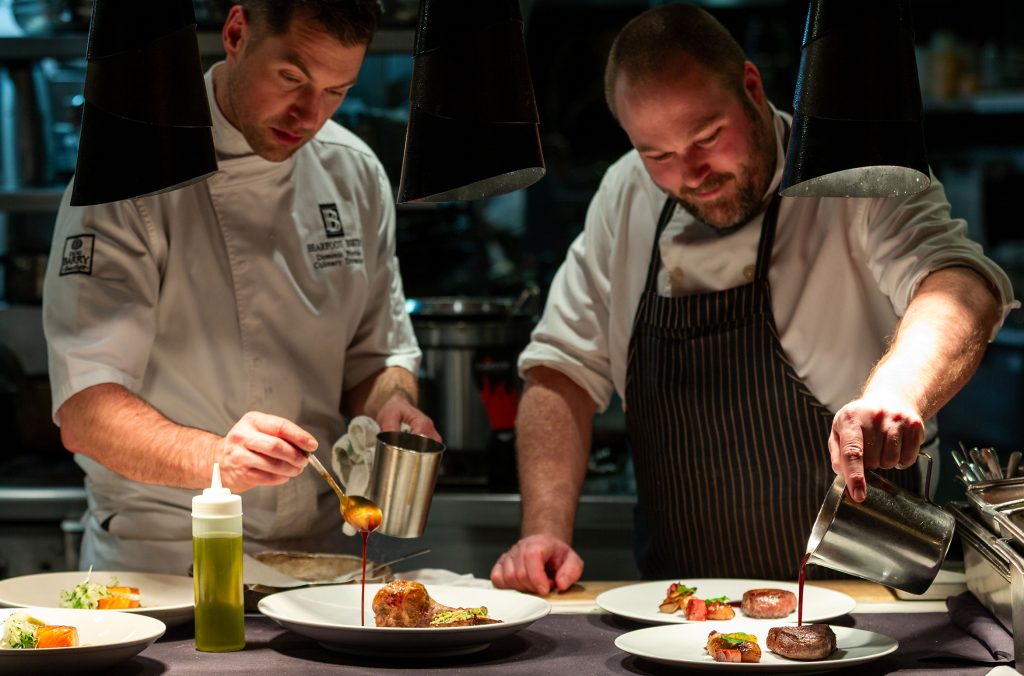 Two chefs prepare food at the Bearfoot Bistro in Whistler.