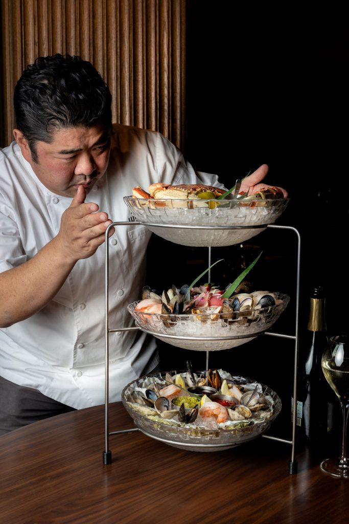 Chef Alex Chen at Wild Blue Restaurant in Whistler adds the finishing touches to a seafood tower.