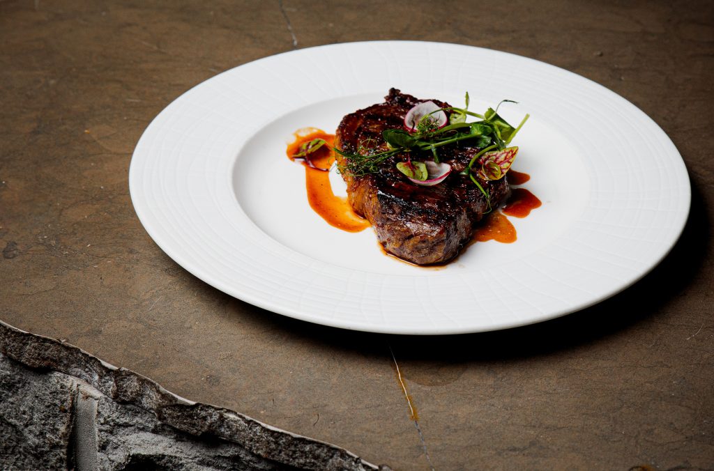 A thick steak takes centre stage on a plate at Four Seasons Resort Whistler.
