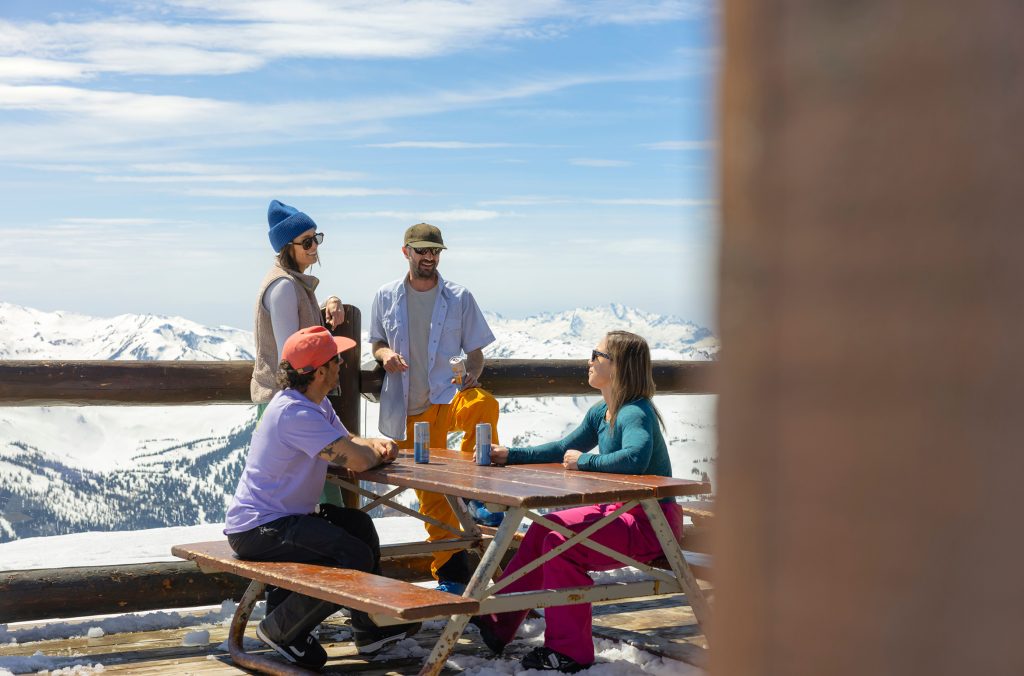 A group of friends enjoy a break from skiing at one of the on-mountain restaurants at Whistler Blackcomb. 