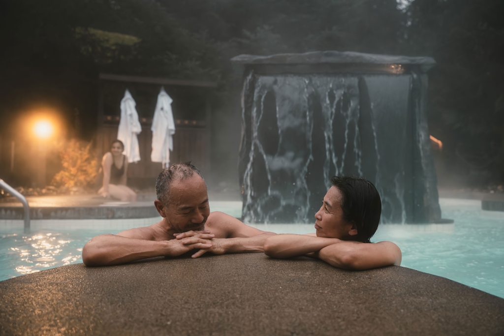 Two people enjoy the hot pool at the Scandinave Spa in Whistler.