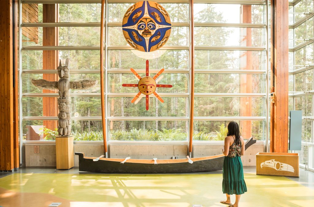 A person looks up at the artwork in the SLCC main gallery in the summer.
