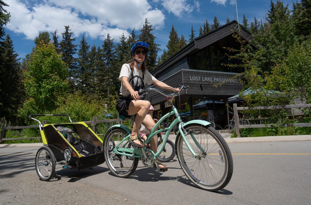 A rider pulls a chariot past the PassivHause at the entrance of Lost Lake Park in Whistler.