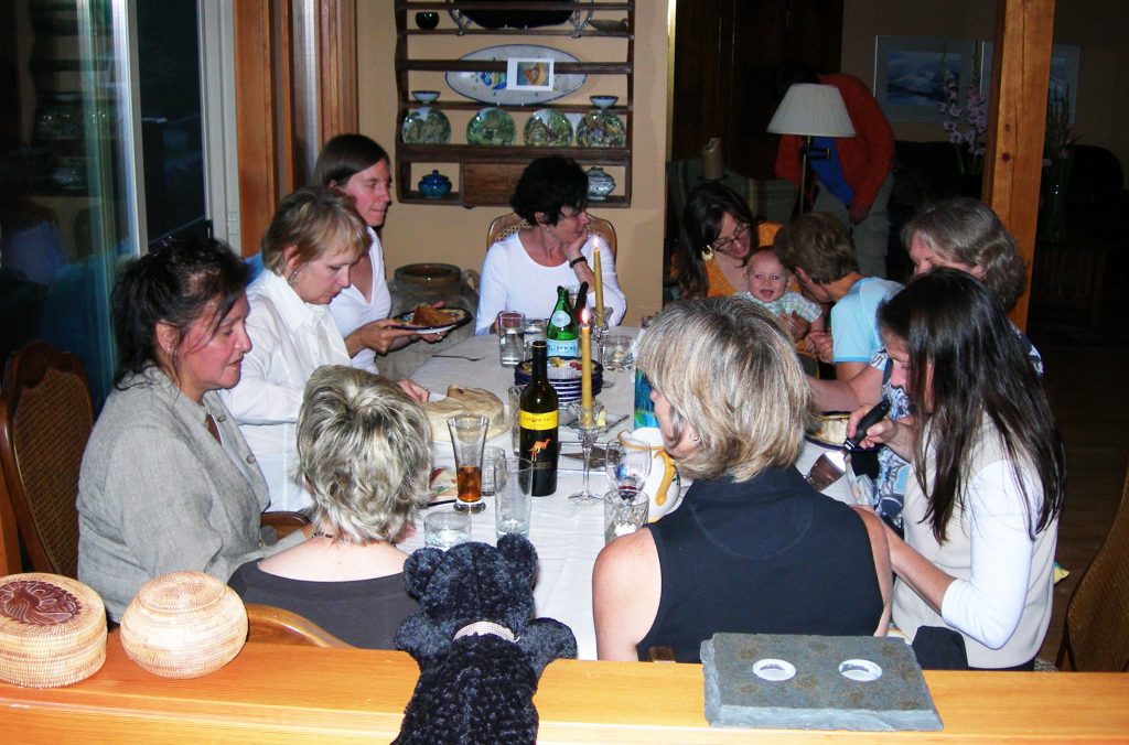 A writers group sits around a large, wood table at Stella Harvey's house in Whistler.