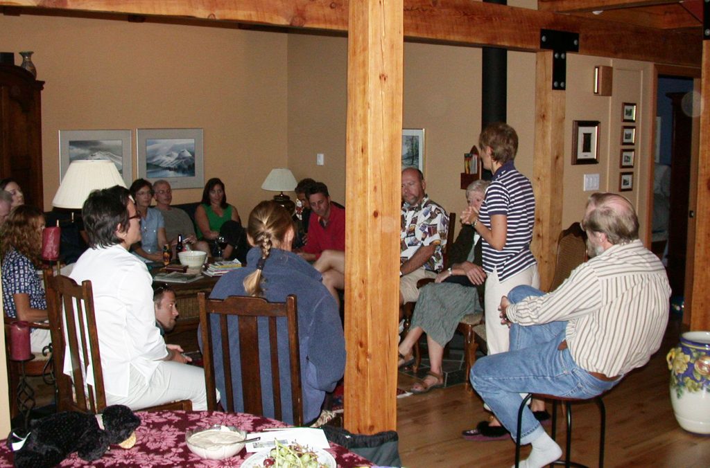 A group of writers gather in Stella Harvey's living room.
