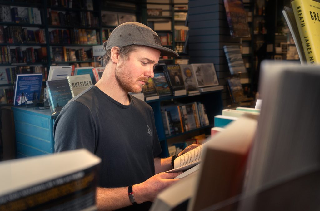 A person browses the books at Armchair Books in Whistler.