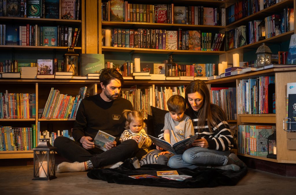 A family sits in Armchair Books in Whistler reading some books.